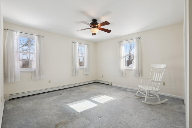 unfurnished room with carpet floors, a baseboard radiator, baseboards, and a ceiling fan