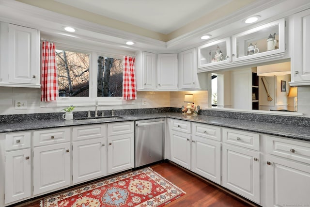 kitchen with a wealth of natural light, white cabinets, a sink, and stainless steel dishwasher