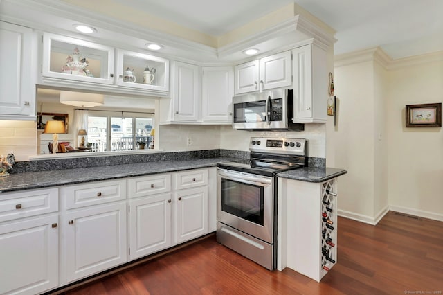 kitchen with tasteful backsplash, baseboards, dark wood-style floors, stainless steel appliances, and white cabinetry