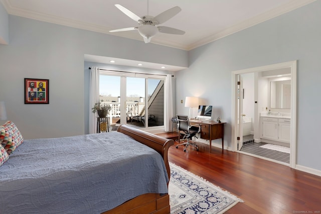 bedroom featuring baseboards, ensuite bath, wood finished floors, and crown molding