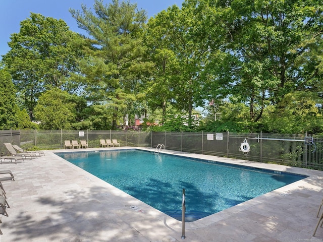 community pool featuring a patio area and fence