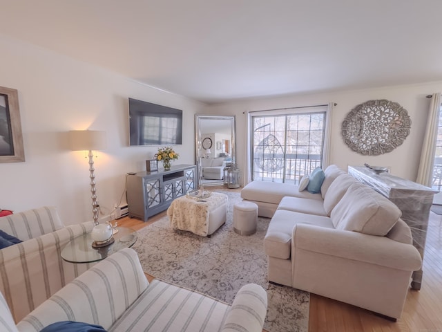 living room featuring baseboard heating and wood finished floors