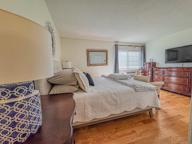 bedroom featuring a textured ceiling and light wood-style floors