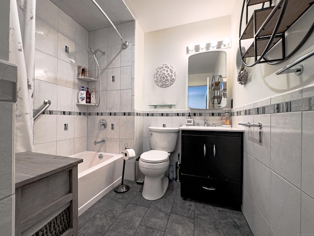 full bath featuring wainscoting, toilet, bathtub / shower combination, vanity, and tile walls