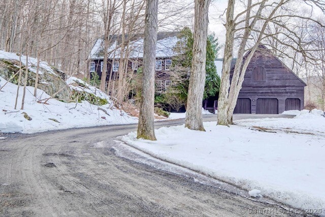 exterior space with a garage, an outbuilding, and a barn