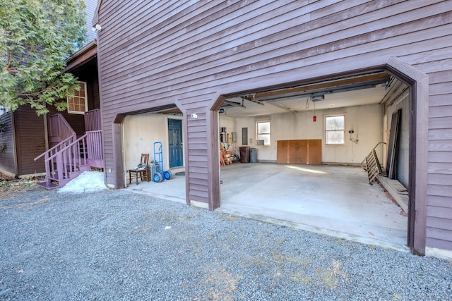 garage with a garage door opener and gravel driveway