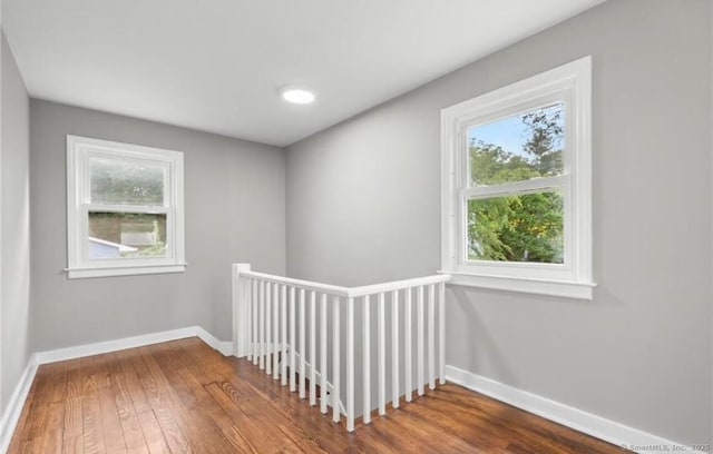 interior space with wood finished floors and baseboards