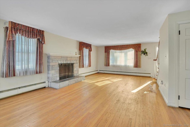 unfurnished living room featuring a baseboard radiator, wood finished floors, stairs, baseboard heating, and a fireplace