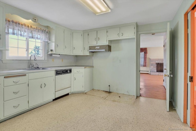 kitchen with dishwasher, range hood, baseboard heating, light countertops, and a sink