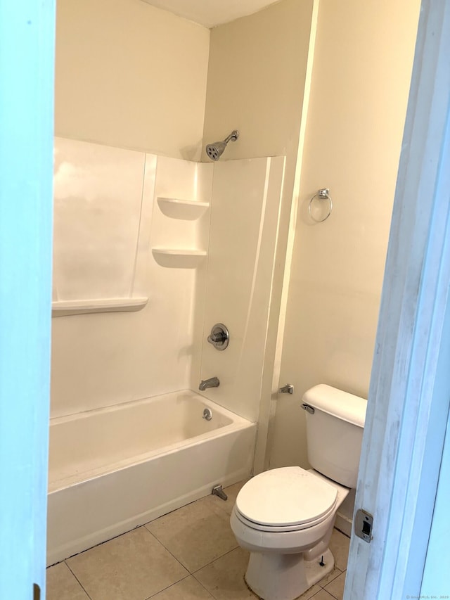 bathroom with shower / tub combination, toilet, and tile patterned floors