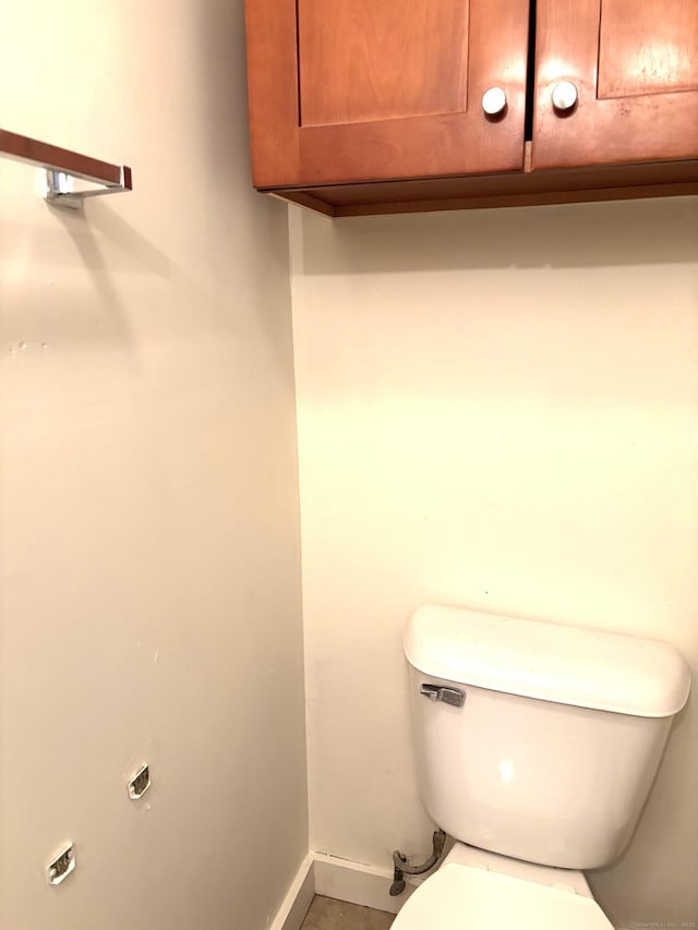 bathroom with toilet and baseboards