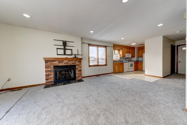 unfurnished living room featuring light carpet and baseboards