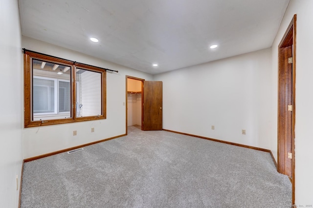 unfurnished room featuring light carpet, recessed lighting, visible vents, and baseboards