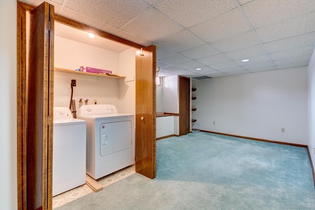 washroom with light colored carpet, laundry area, baseboards, and washing machine and clothes dryer