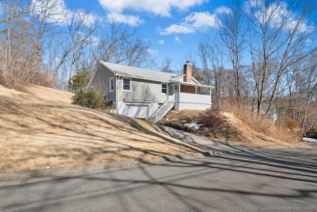 exterior space featuring a chimney and an attached garage