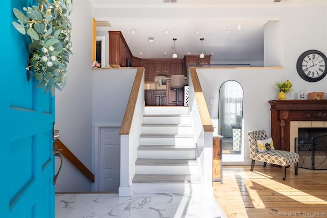 interior space featuring marble finish floor, a fireplace, visible vents, and recessed lighting