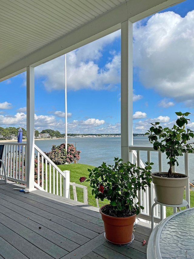 wooden deck featuring a water view