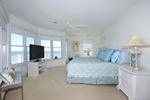 bedroom with a ceiling fan and light colored carpet