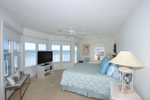 bedroom featuring visible vents, baseboards, ceiling fan, and light colored carpet