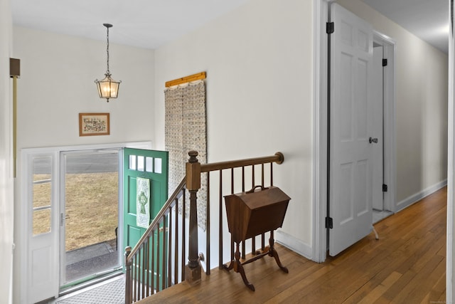 foyer entrance with hardwood / wood-style flooring and baseboards