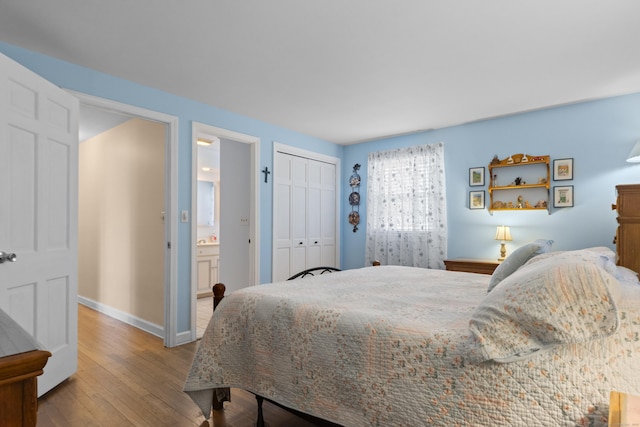 bedroom featuring a closet, baseboards, and wood finished floors