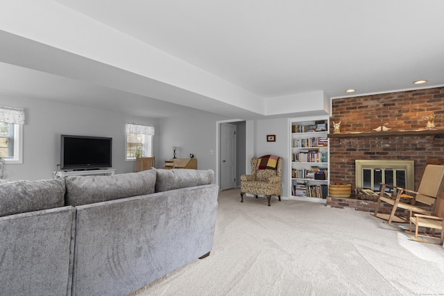 living room featuring carpet floors, recessed lighting, a brick fireplace, and built in shelves