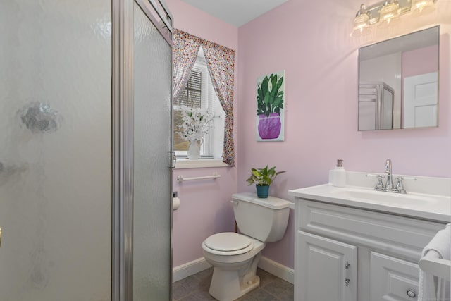 bathroom with vanity, tile patterned flooring, a shower stall, and toilet