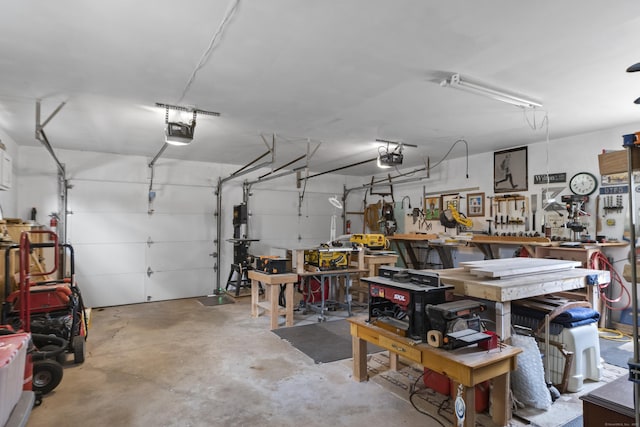 garage with a garage door opener and a workshop area