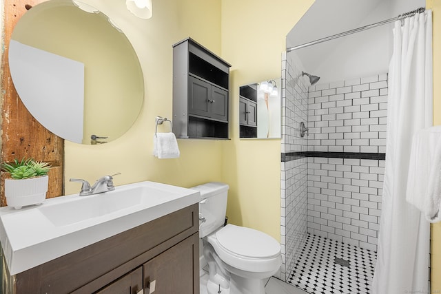 bathroom featuring a stall shower, vanity, and toilet