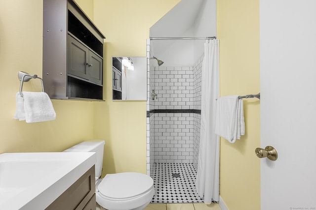 full bath with vanity, a shower stall, toilet, and tile patterned floors