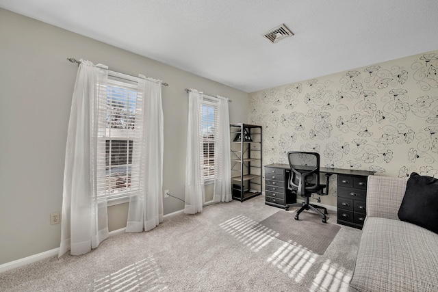 office area with light carpet, baseboards, visible vents, and a textured ceiling