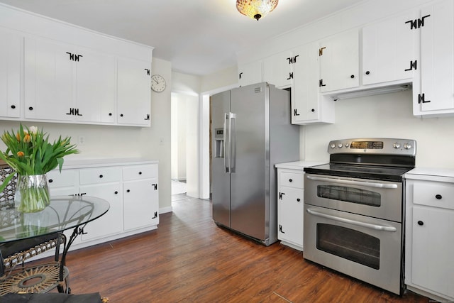 kitchen featuring light countertops, appliances with stainless steel finishes, dark wood finished floors, and white cabinets