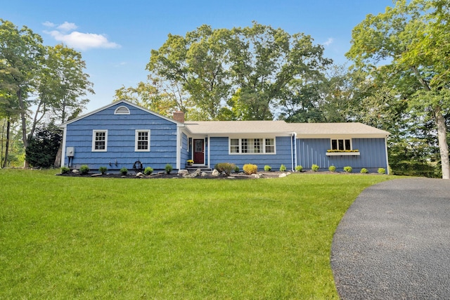 view of front of home with a front lawn and a chimney