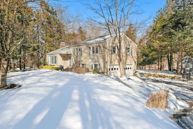 view of front of property with a chimney and an attached garage