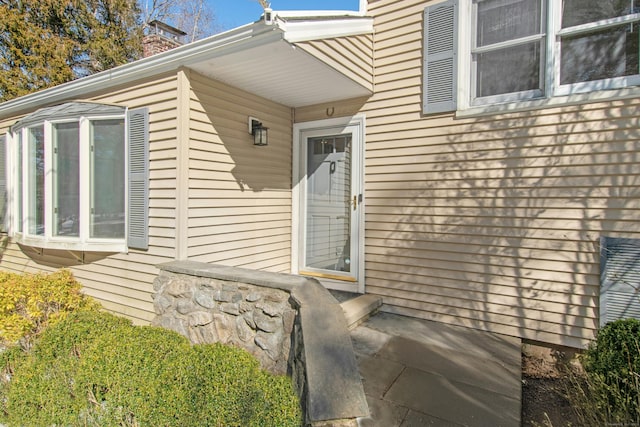 doorway to property featuring a chimney