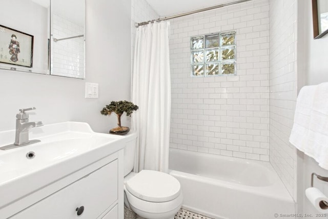 full bath featuring a sink, shower / tub combo with curtain, and toilet