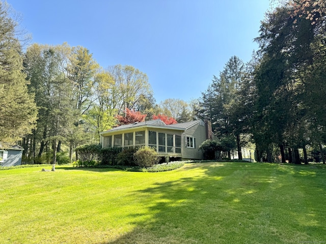 view of yard featuring a sunroom