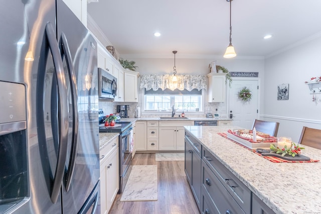 kitchen with stainless steel appliances, white cabinetry, and gray cabinetry