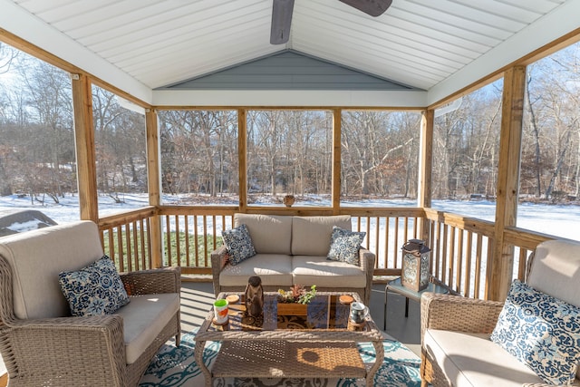 sunroom featuring lofted ceiling, ceiling fan, and a wealth of natural light