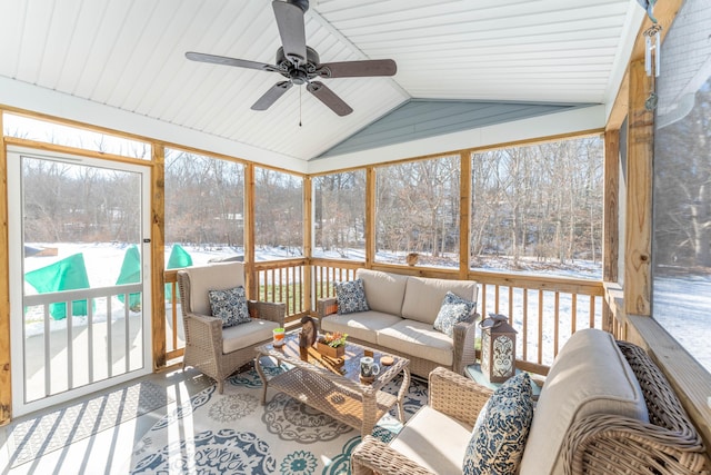 sunroom / solarium with lofted ceiling, a ceiling fan, and a wealth of natural light