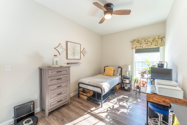 bedroom featuring ceiling fan, baseboards, and dark wood-type flooring