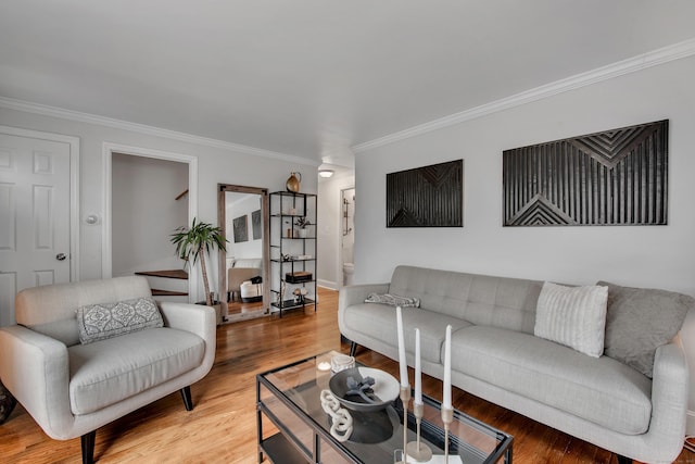 living room featuring light wood finished floors and crown molding