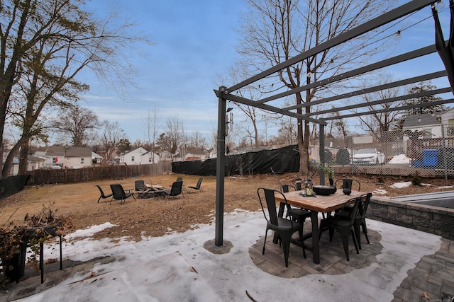 view of patio / terrace featuring a fire pit, outdoor dining space, and a fenced backyard