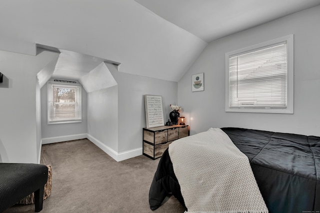 carpeted bedroom featuring lofted ceiling and baseboards