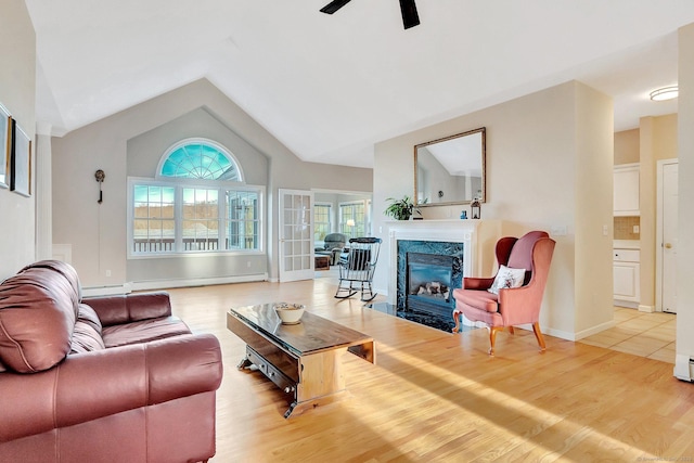 living room featuring wood finished floors, a fireplace, and vaulted ceiling