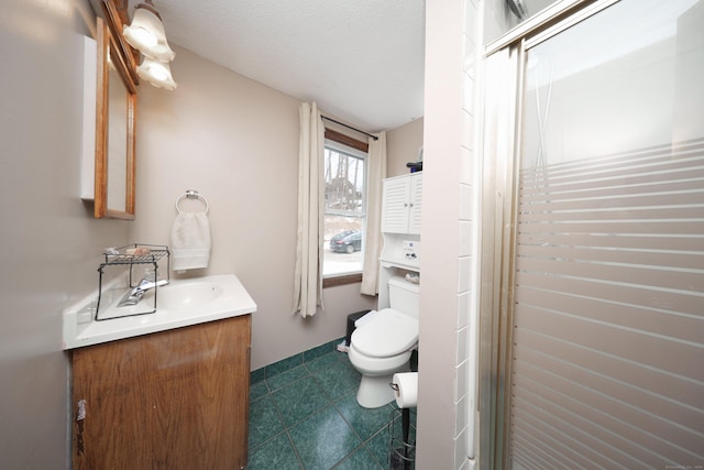 full bathroom with a textured ceiling, tile patterned flooring, toilet, vanity, and a stall shower