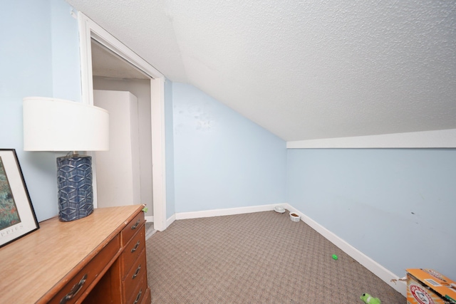 bonus room featuring a textured ceiling, vaulted ceiling, carpet flooring, and baseboards