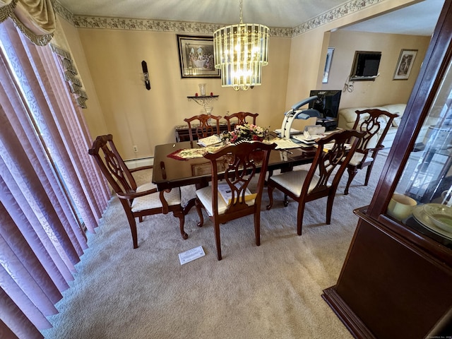 dining area featuring a notable chandelier, baseboard heating, and light colored carpet