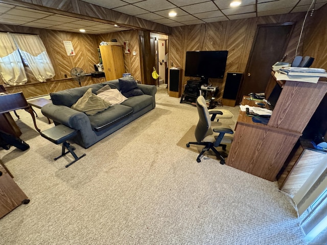 carpeted office space featuring recessed lighting, a drop ceiling, and wooden walls