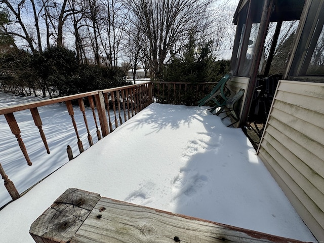 yard covered in snow featuring a deck